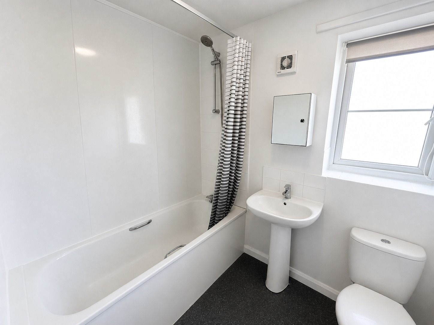 Bathroom with bath, shower and window