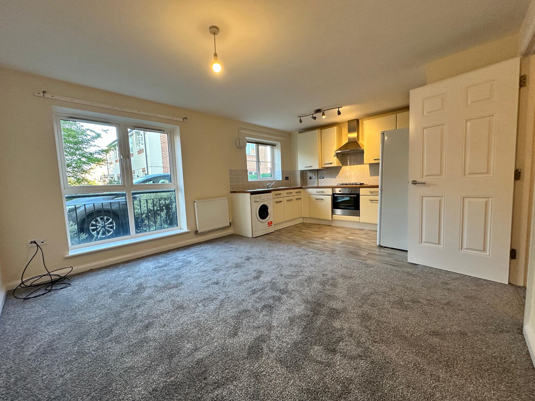 Open-plan living area and kitchen with a large window